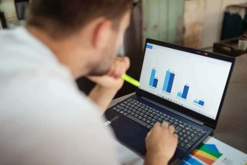 A founder reviewing business charts on a laptop